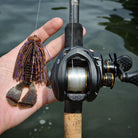 Motion Fishing PBJeli Football Jig with a Spicy Beaver Craw in the hand of an angler with a St. Croix fishing rod and Lews Reel