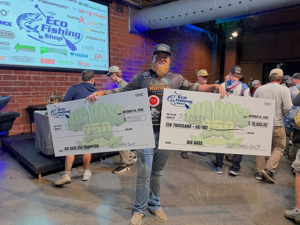 PJ Coley holding his $7,000 Big Bass 250 Champion and $10,000 Big Bass checks, won on Lake of the Ozarks with Motion Fishing baits