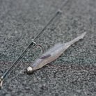 Purple Shad Motion Minnow rigged on a jig head laying on the deck of a boat. 